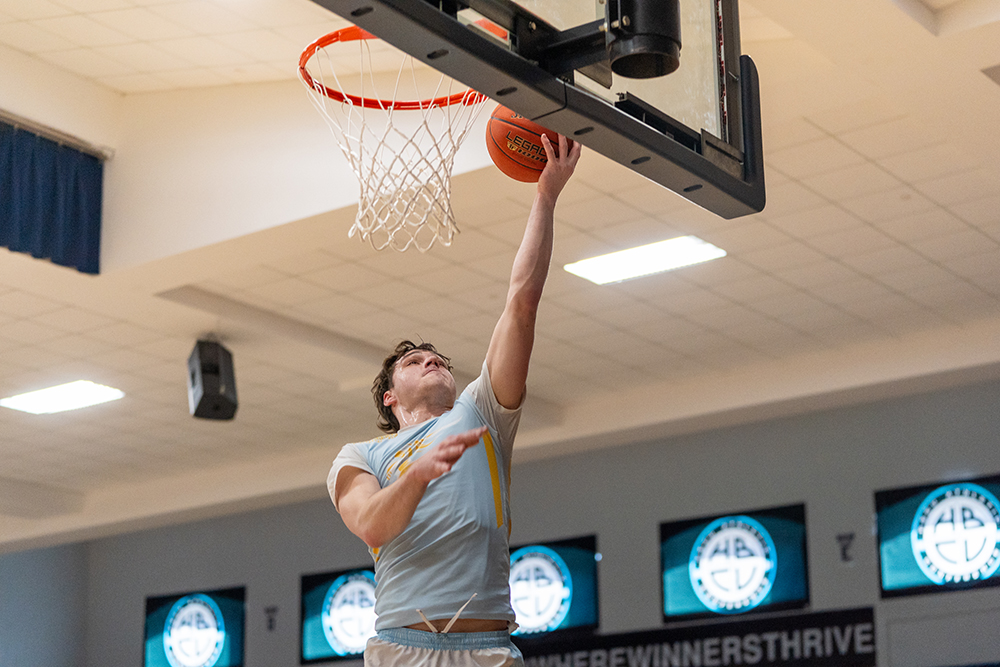 A person playing basketball in a gym AI-generated content may be incorrect.