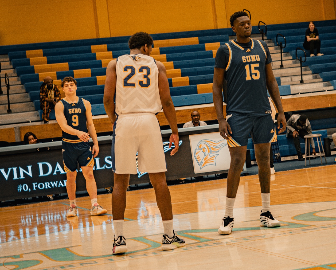 A group of men in basketball uniforms on a basketball court AI-generated content may be incorrect.